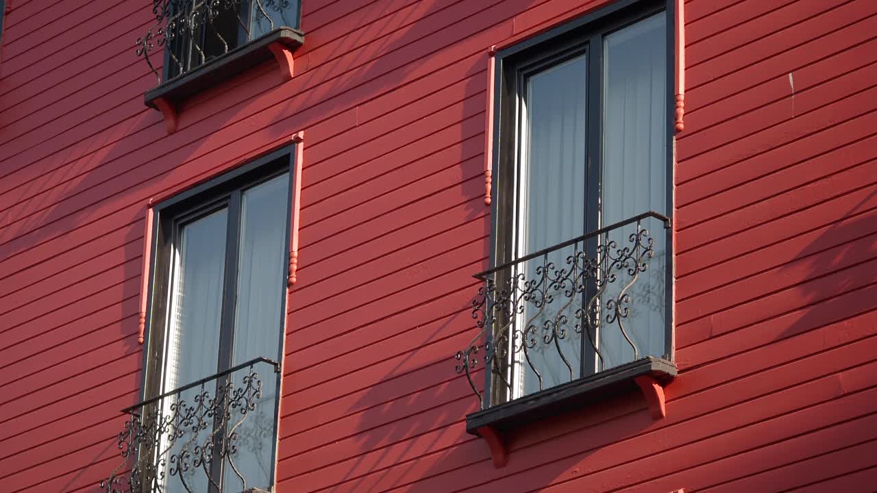 Red building with windows and balconies