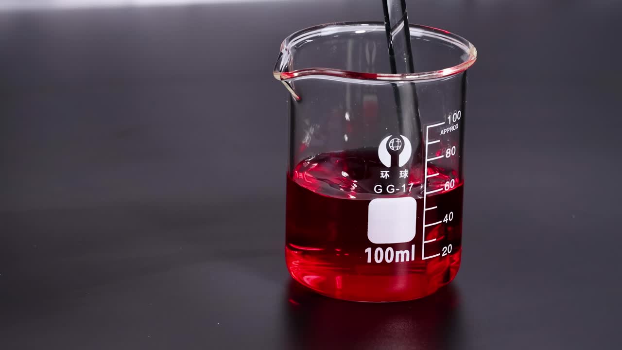 Experiment with red liquid in a beaker