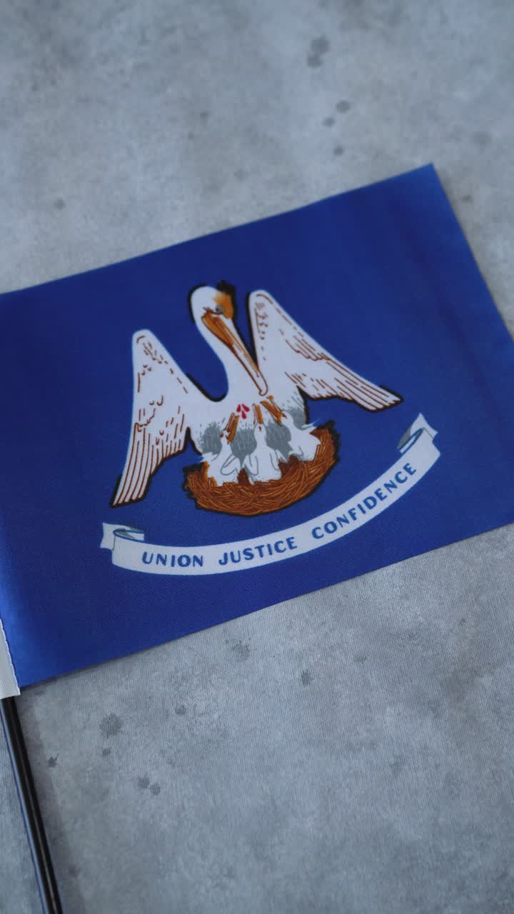 Lousiana state flag. Vertical shot, camera orbiting and zoom in