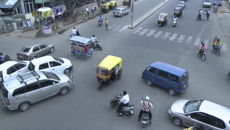 Vehicles-and-pedestrians-travel-through-a-busy-intersection