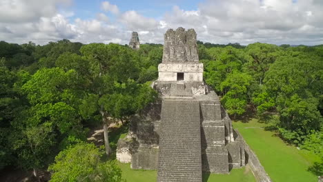 spectacular aerial shot over the tikal pyramids in guatemala 1