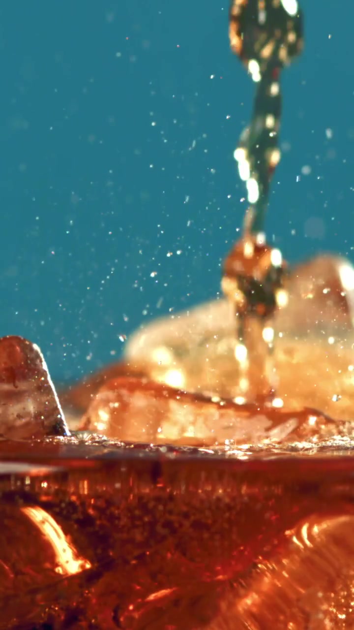 Refreshing Cola Drink Poured Over Ice in Slow Motion