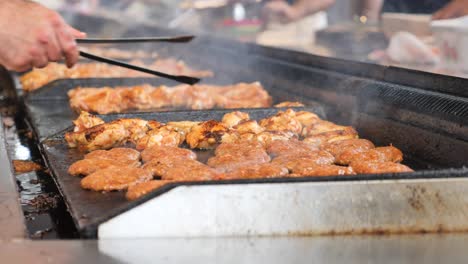 grilled meats and burgers on a commercial grill