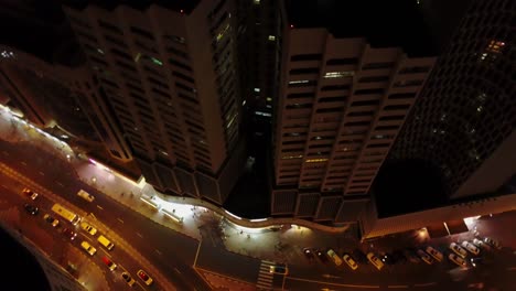 night aerial view of city intersection with high-rise buildings