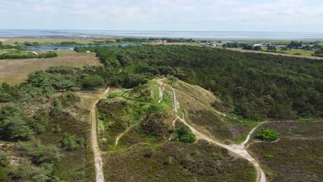 Aerial-view-green-hills-and-rural-countryside-in-summer-sun-in-Denmark