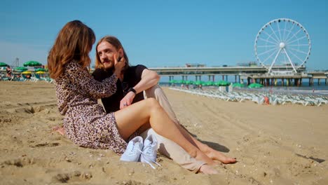 a woman and a man are sharing a kiss on the beach - medium shot