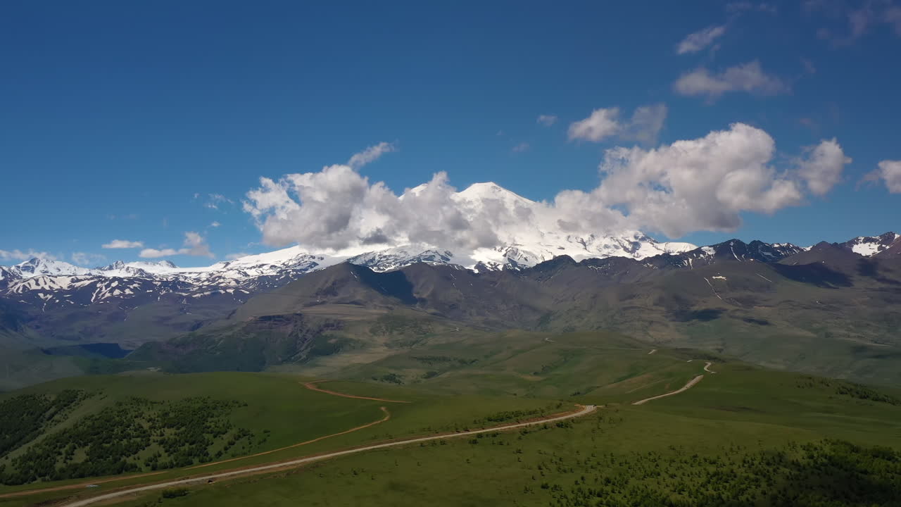 Elbrus Region. Flying over a highland plateau. Beautiful landscape of nature. Mount Elbrus is visible in the background.