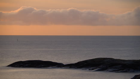 dreamy orange and blue ocean sunrise time lapse with puffy clouds