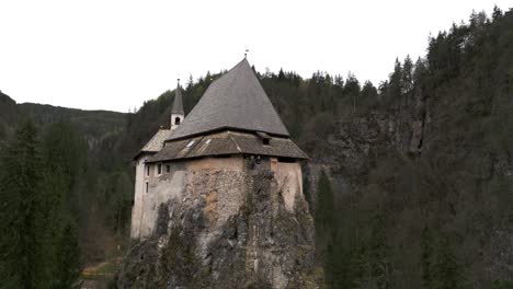 sanctuary castle on a mound surrounded by trees