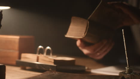 old passionate man read a book in his office at night
