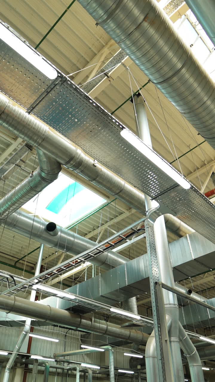 View of the ventilation system of the parquet factory. Camera motion to forward Vertical video