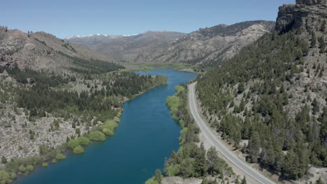 aerial - road and limay river in valle encantado, patagonia, neuquen, argentina, pan right