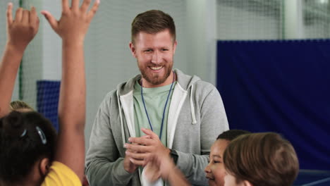 kids and trainer with hands on the center