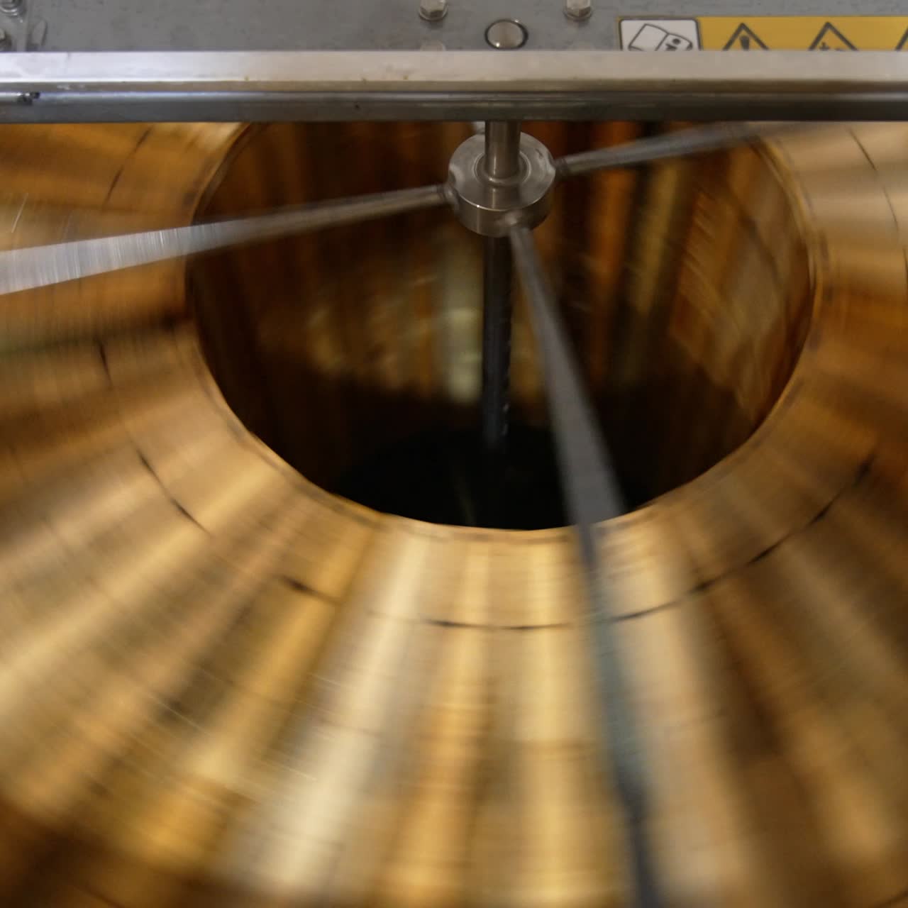 Honey frames rotated in the honey extractor machine. Close up. Top view. Apiarist's equipment for producing organic honey