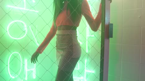 beautiful african american girl walking in a neon room-club