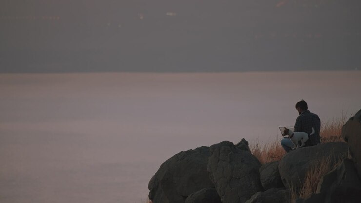 A man working on the edge of a cliff