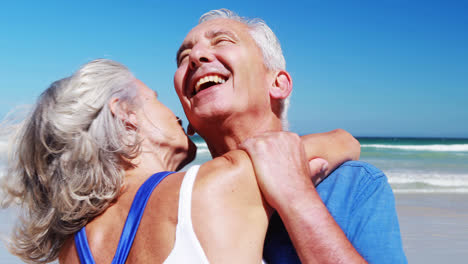 Senior-couple-hugging-each-other-at-the-beach