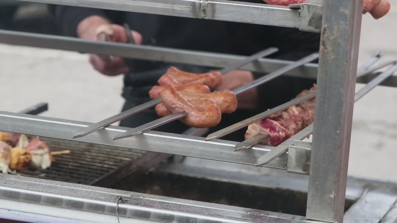 Chef expertly flipping hot dogs and sausages on commercial grill in slow motion. Perfect for restaurant marketing, culinary training, and food service industry content