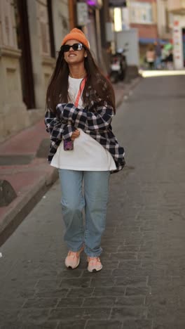 stylish young woman walking down a city street