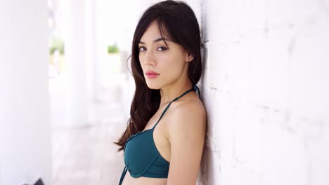 gorgeous woman leaning against wall