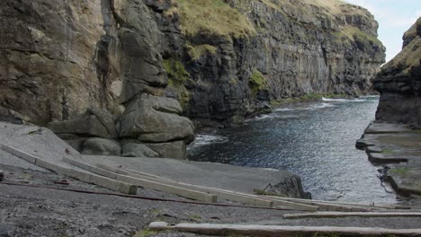 wide pan right of gjogv natural harbor in the faroe islands