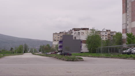 old, brutalist apartment buildings next to a road in post communist bulgaria in eastern europe