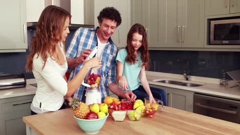 happy family making smoothie