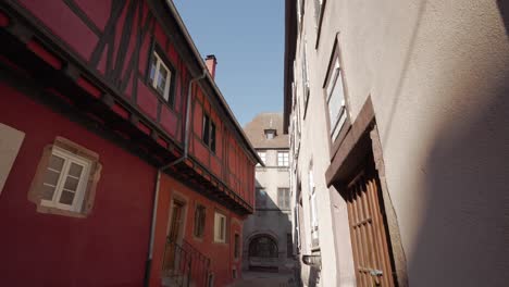 Scenic-colourful-half-timbered-houses-in-medieval-french-village-with-gobblestone-roads