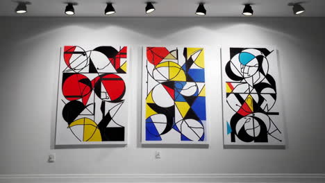 abstract geometric paintings in primary colors displayed on a wall
