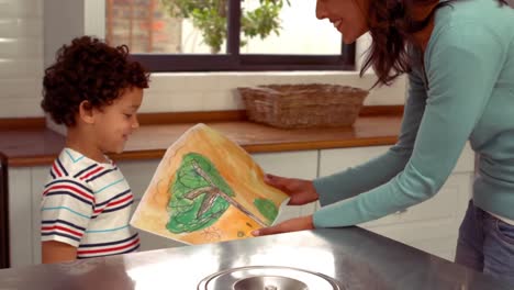 Smiling-Hispanic-mother-receiving-a-present-from-her-son