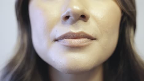 an up close shot on the lips of a hispanic female as she says yes in multiple styles and speeds