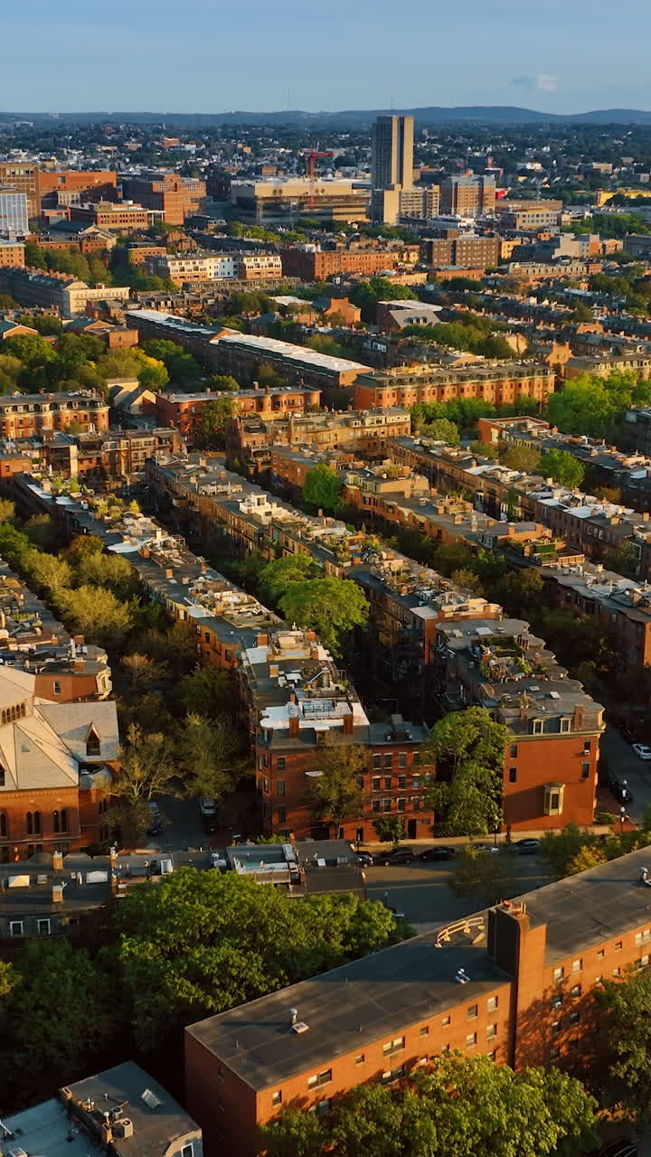Rows of blocks of flats in the residential area of Boston. View of rooftops and streets from top. Vertical video