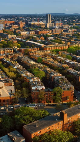 rows of blocks of flats in the residential area of boston. view of rooftops and streets from top. vertical video
