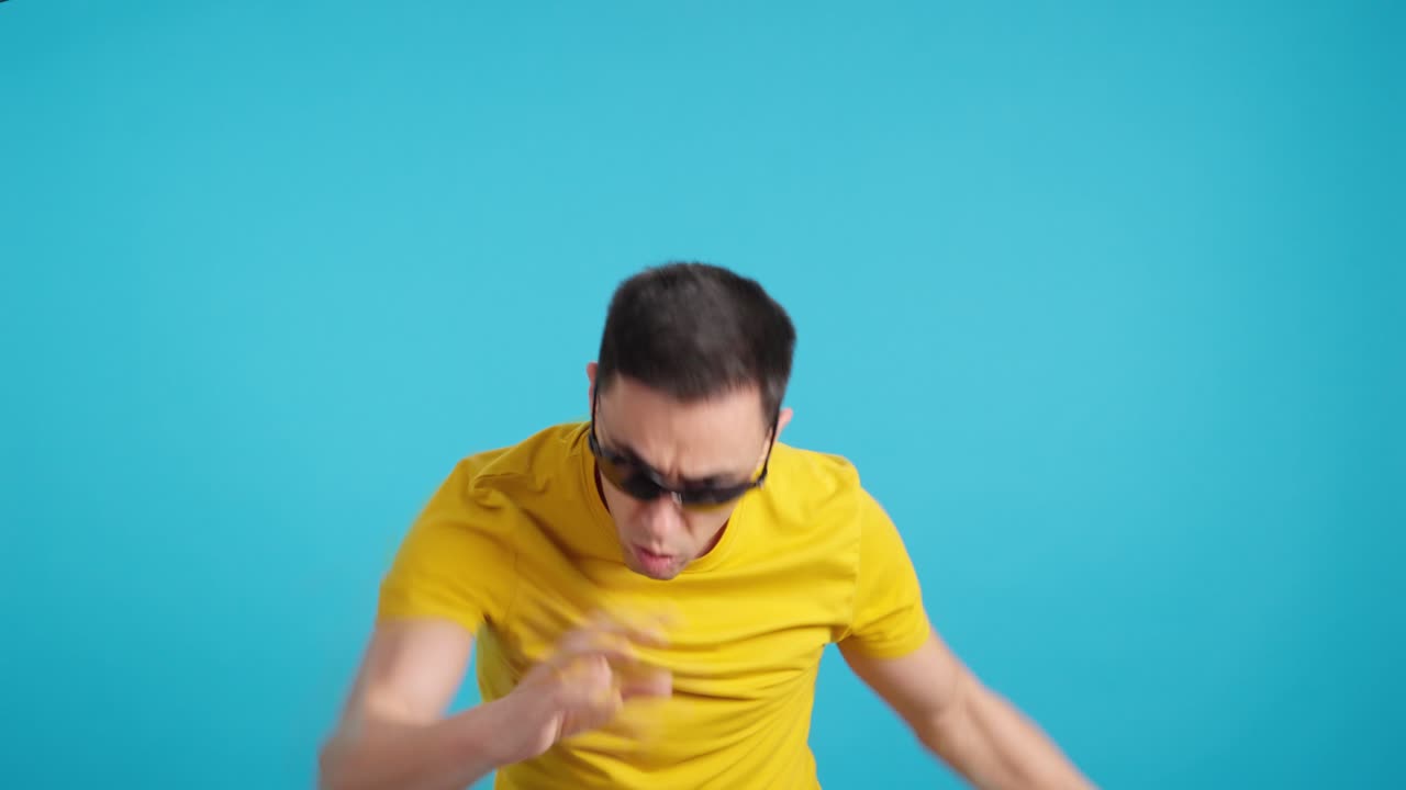 Man with sunglasses in yellow shirt