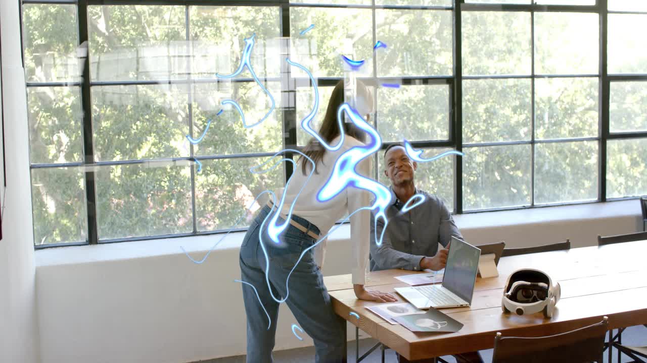 Standing woman leaning over table and starting AR demo for tech review blue ribbons circling laptop