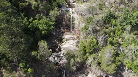 People-enjoying-the-natural-pools-at-Fecha-de-Barjas-waterfall,-Peneda-Gerês-National-Park
