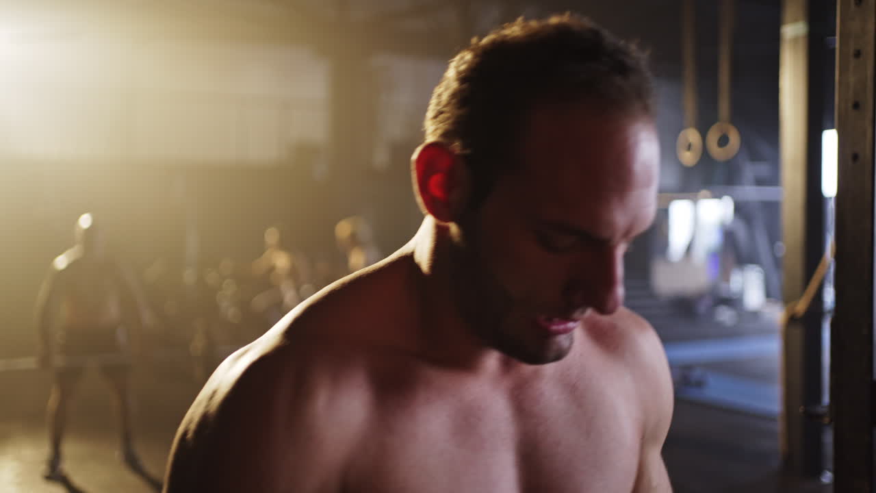 Man doing pull ups in a gym