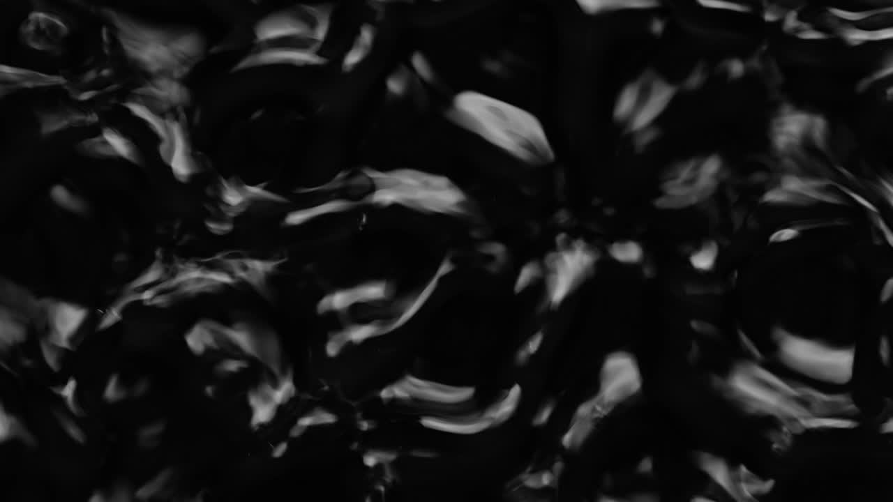 Splashes and drops on the surface of the liquid. Abstract Black Background Water vibration