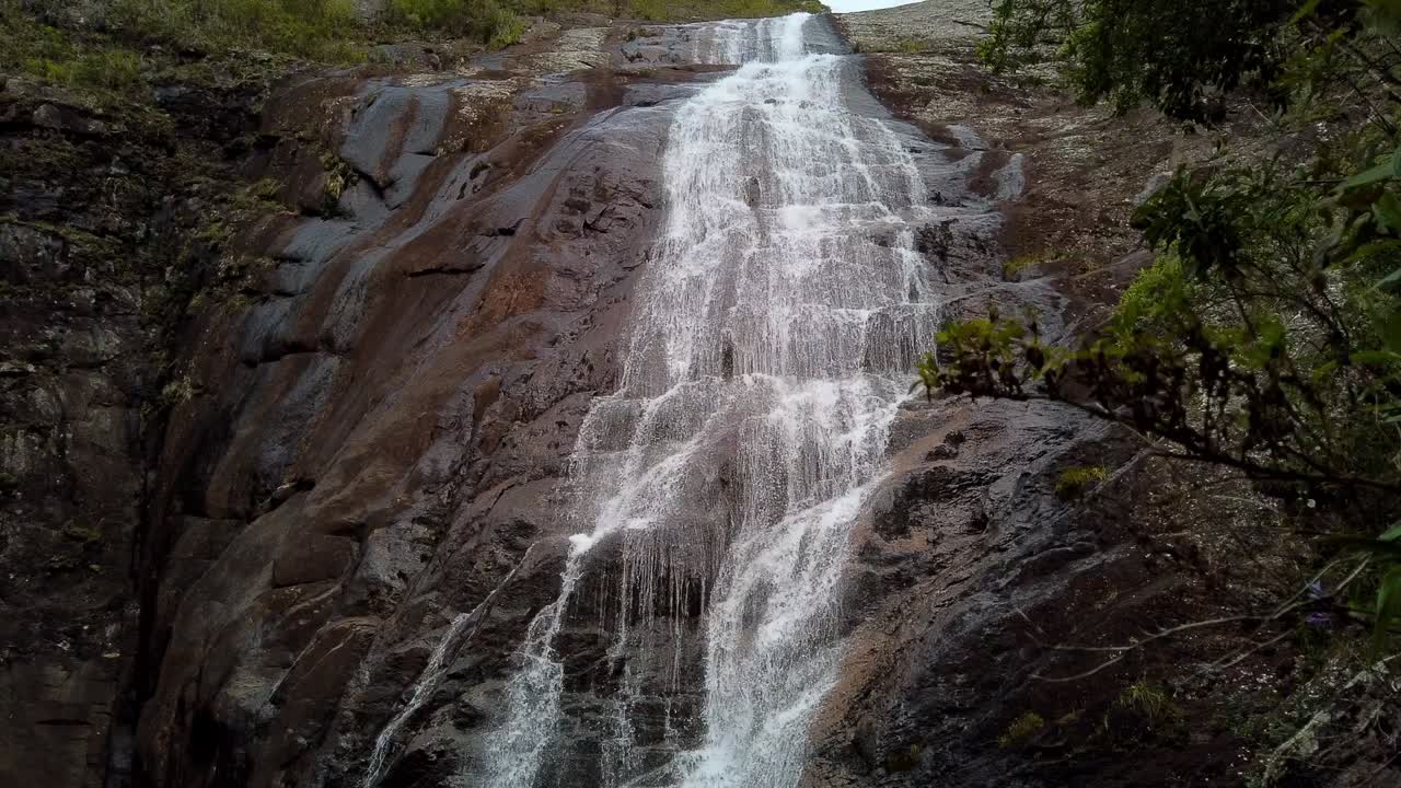 Waterfall flowing over rocks, lush nature scene in Mantiqueira, Minas Gerais, hyperlapse