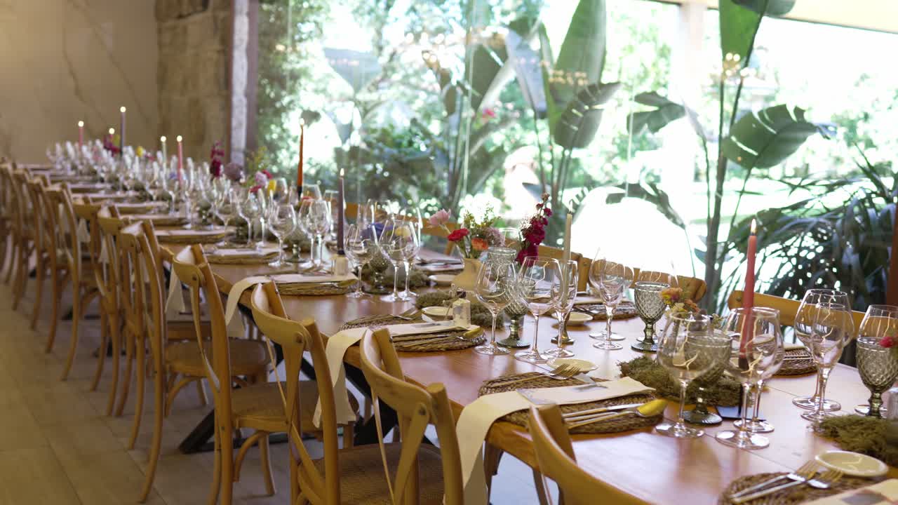 Beautifully arranged long wedding table with candles, floral decor, and glassware