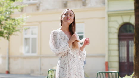 thoughtful smiling happy young woman with pensive expression pondering a solution dreaming thinking