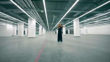 empty hall with a beautiful woman playing the violin