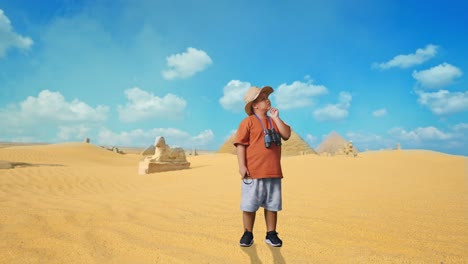 asian boy with a hat, binoculars, and magnifying glass thinking about something and looking around while traveling in giza pyramid. boy researcher, travel adventure, full body