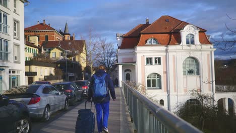 historic town of tubingen germany | female tourist pulling luggage at sunset