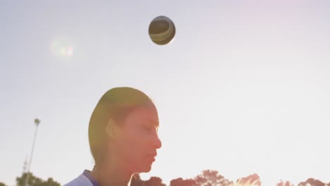 female soccer player shooting ball with her head 4k