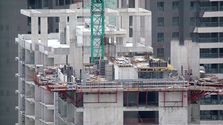 Construction Workers Building High-Rise Skyscraper Structure