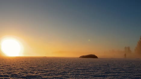 tourists cross-country skiing and enjoying lovely golden sunset in fantastic arctic winter landscape