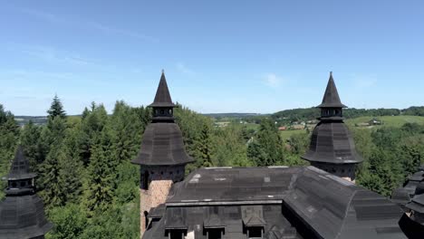 abandon polish castle with majestic towers, aerial fly extremely close up