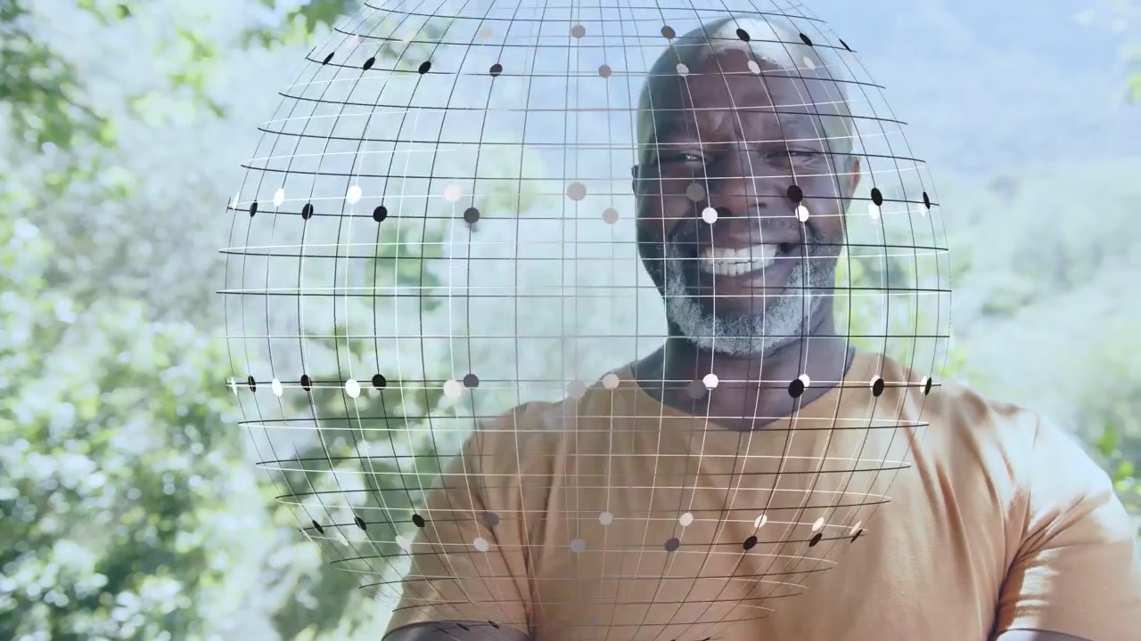Vertical video: Man laughing and leaning as wire grid moving from left wrapping head, showing tech
