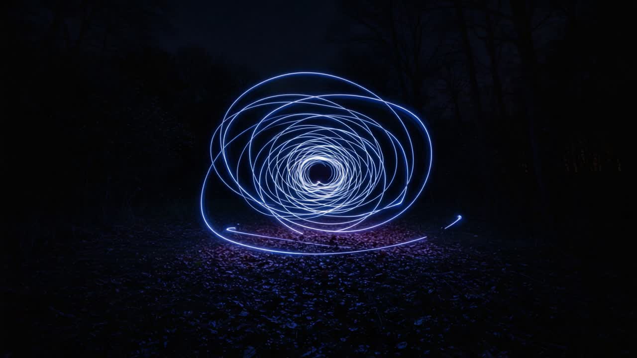 Captivating Swirls of Blue Light: A Mesmerizing Display of Motion and Energy in a Darkened Forest Setting, Creating Intricate Patterns of Luminescence